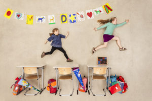 School kids chasing in class room