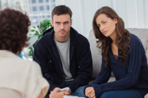 Couple sitting on couch listening to therapist